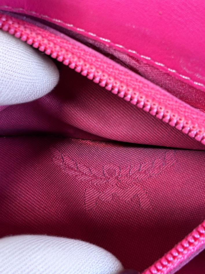 MCM Sweet Visetos interior zippered coin pocket with bright pink lining, MCM-stamped zipper pull, and visible light coin dust