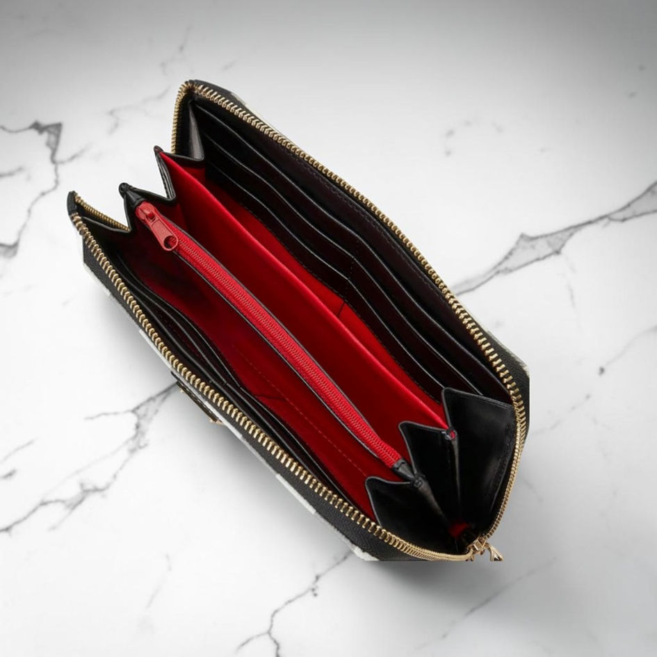 Dooney & Bourke Tucker wallet open interior with red fabric lining, black leather card slots, and center zipper.