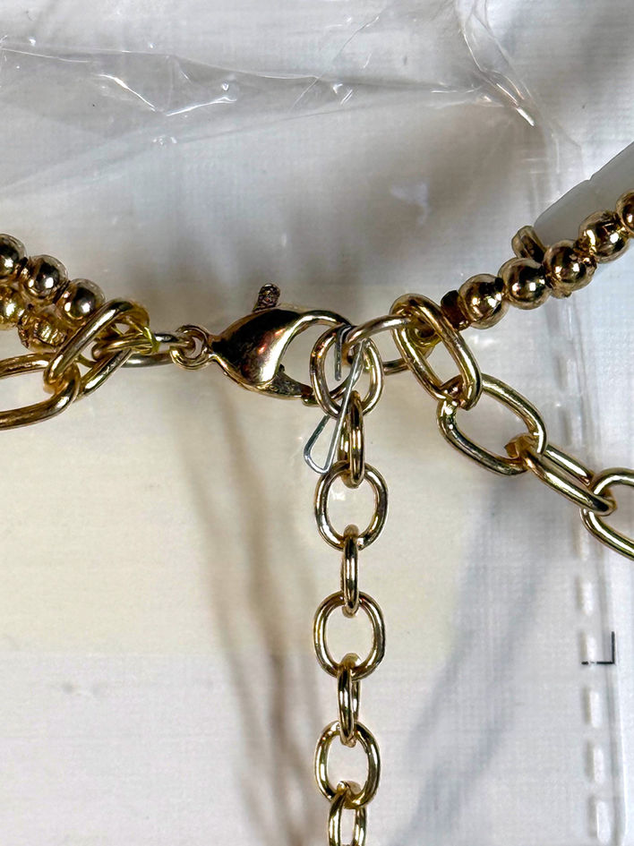 Close-up of gold-tone clasp and extender chain on Myra Bag Heart Of The Sea necklace