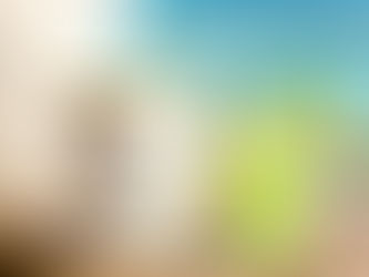 a candle with a cocktail by the water