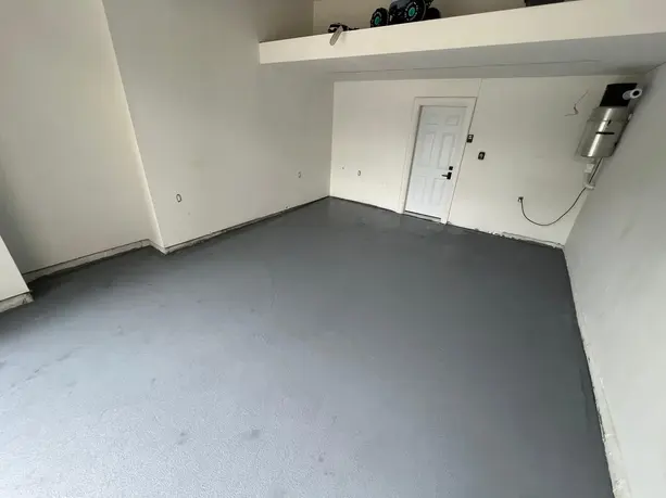 Durable gray epoxy garage floor for a sleek stain-resistant and easy-to-clean finish perfect for enhancing strength and style in any garage space