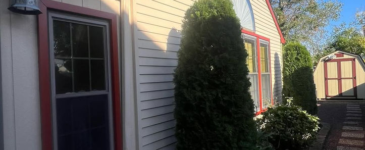 Back exterior refreshed with clean siding, detailed window trim, and updated soffits. Designed for both aesthetics and weather resistance in high-use outdoor areas