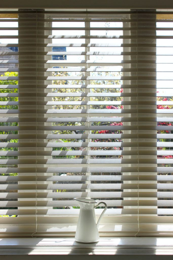 My husband and I recently bought our first home! With it, has come a lot of learning. One of the first things we realized when we moved into our house was there were no blinds! With large sliding doors on the backside of each of our three levels, we felt a bit like we were living in a zoo where everyone could peer in. So one of the first things on our list was to put up some vertical blinds.