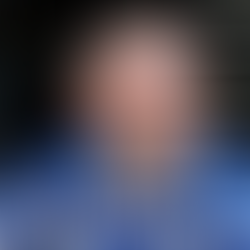 Wayne Rooney after hair transplant with full hairline, sitting in training kit