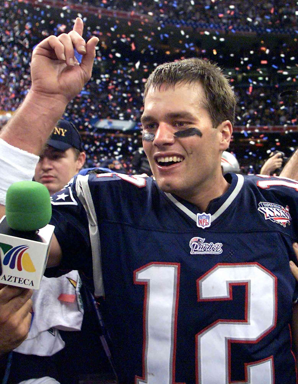 Tom Brady celebrating Super Bowl victory smiling on the field