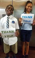 2 kids with thank you signs.jpg