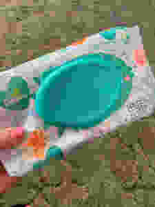 lady holding a pack of of pampers wipes