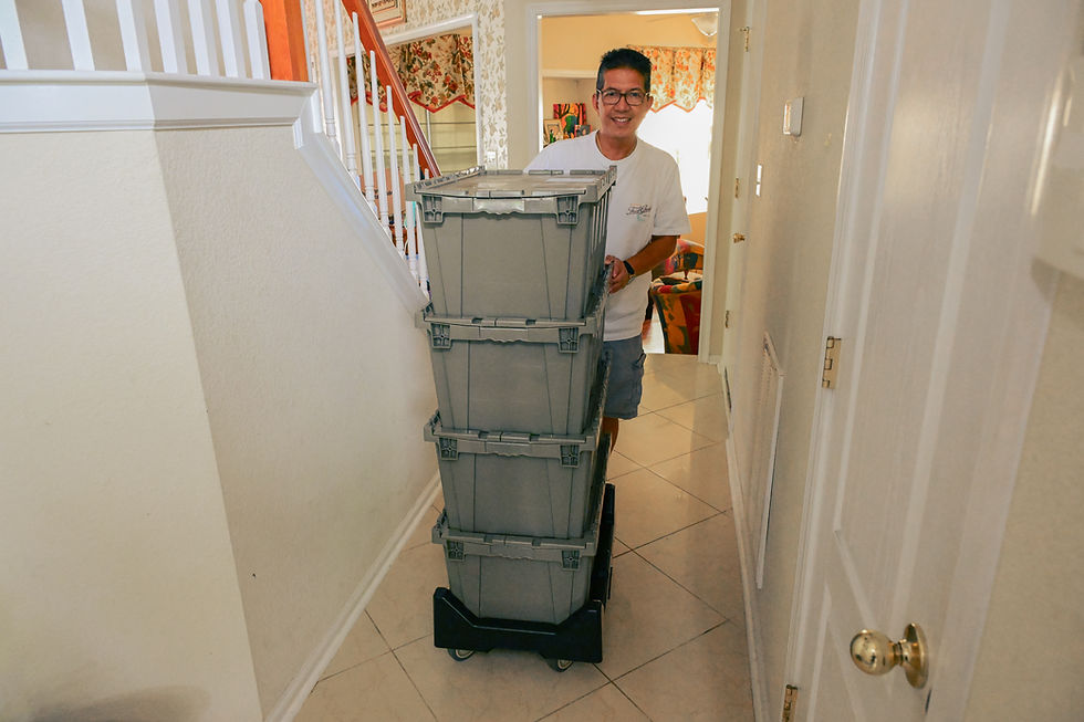 Customer moving stackable rental boxes on dolly in Virginia Beach Hampton Roads area