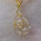 Thumbnail: Elegant gold wire-wrapped crystal pendant
