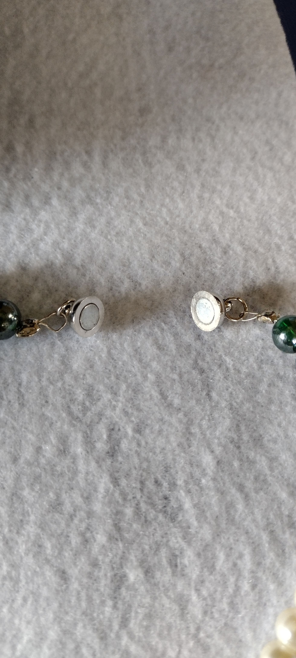 Thumbnail: Magnetic clasp close-up of dark green pearl necklace