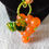 Thumbnail: Elegant orange and green beaded necklace pendant up close