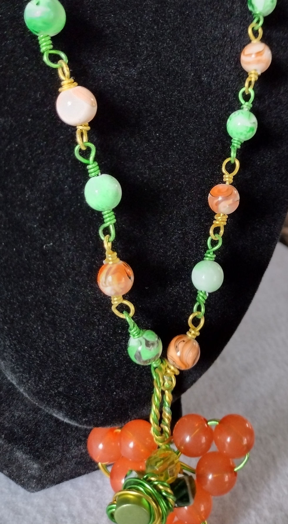 Thumbnail: Elegant green and orange beaded necklace with gold wire accents