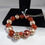 Thumbnail: Elegant beaded bracelet with red and beige pearls