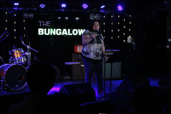 Photo of poet Georgia Bartlett-McNeil performing on The Bungalow stage.