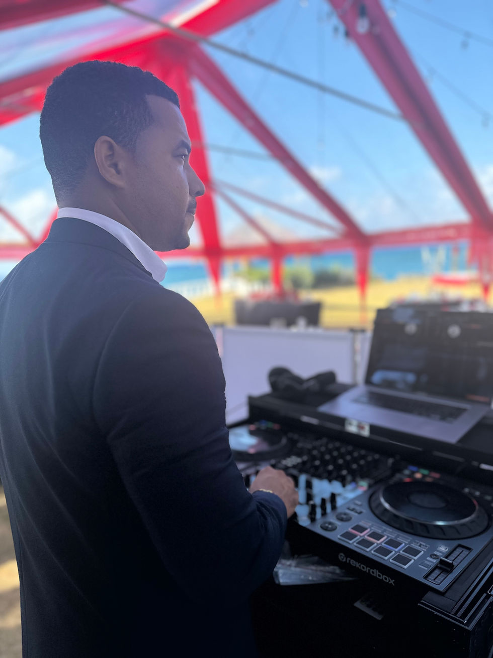 Eye-level view of a wedding DJ setting up sound equipment at an outdoor venue
