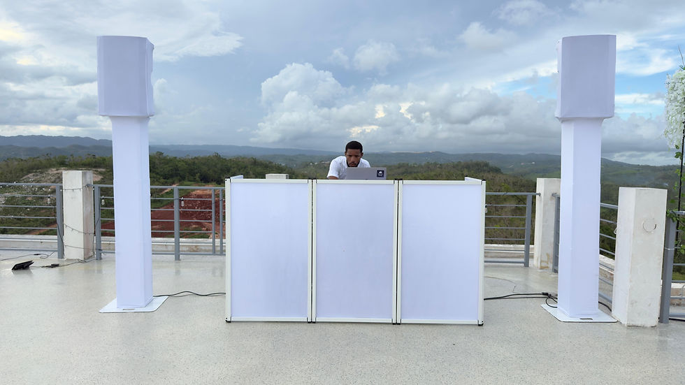 Eye-level view of DJ setup with speakers and lighting at an event