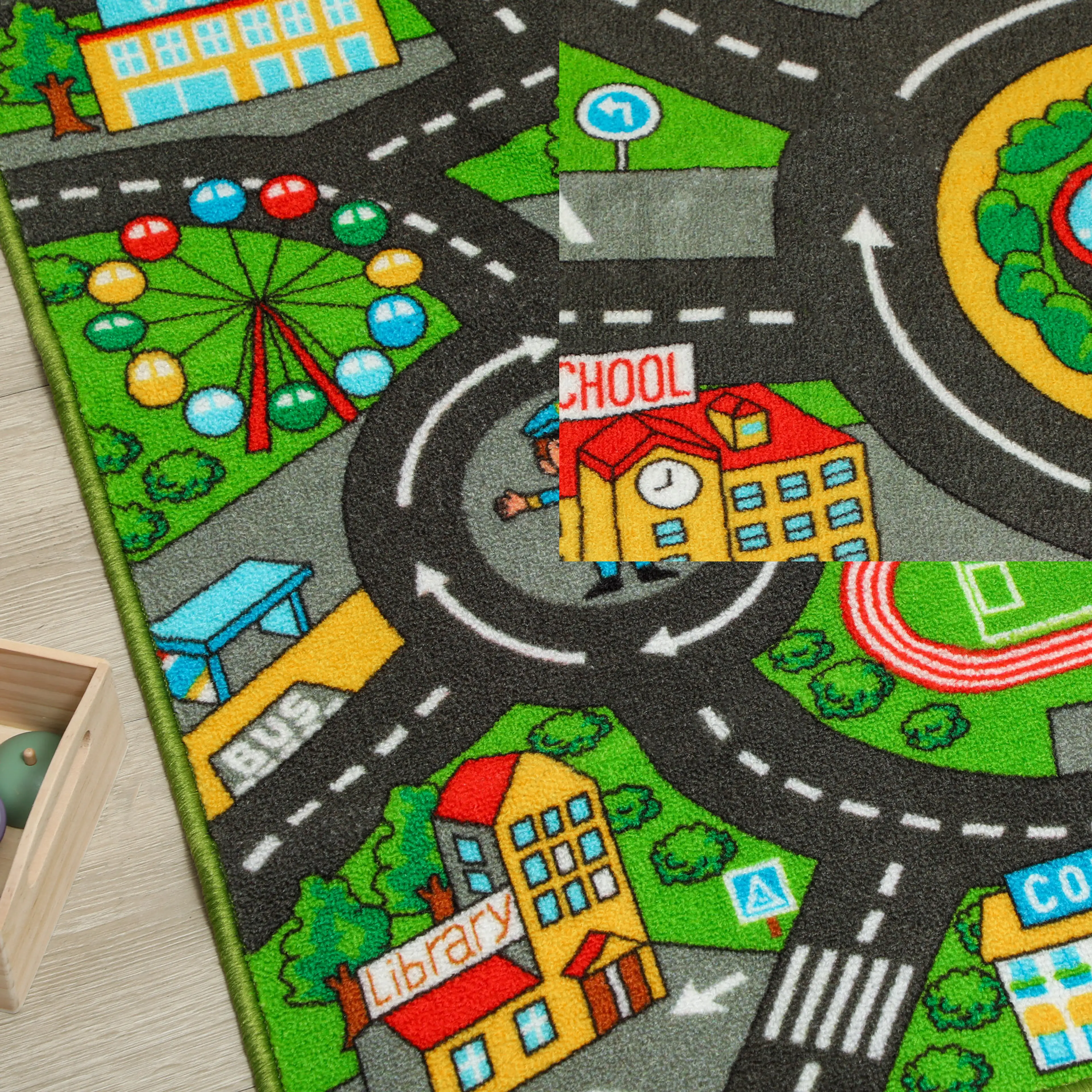 Närbild på mattans motiv med pariserhjul, rondell, skola och bibliotek