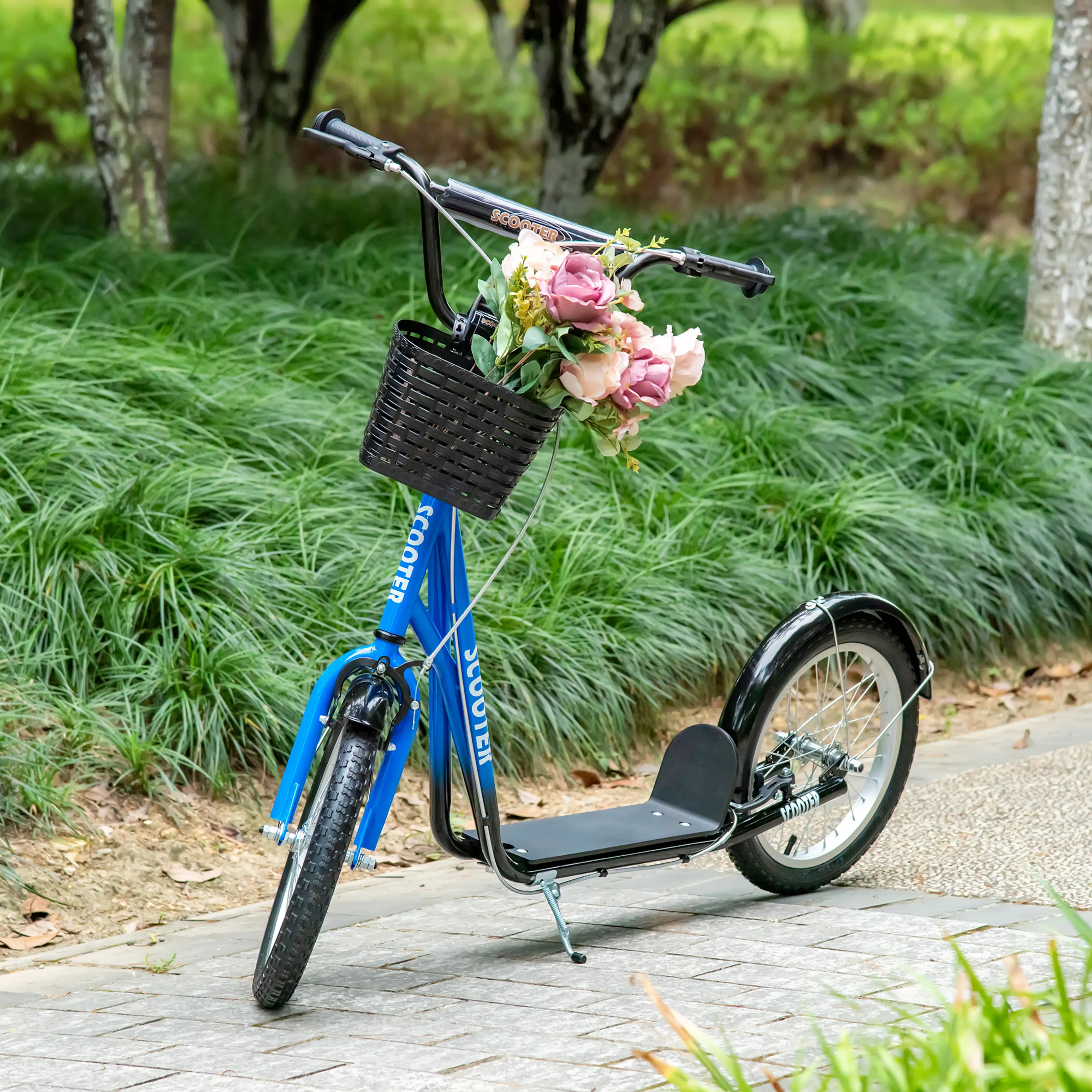 Blå sparkcykel med blommor i korgen vid en gräsmatta