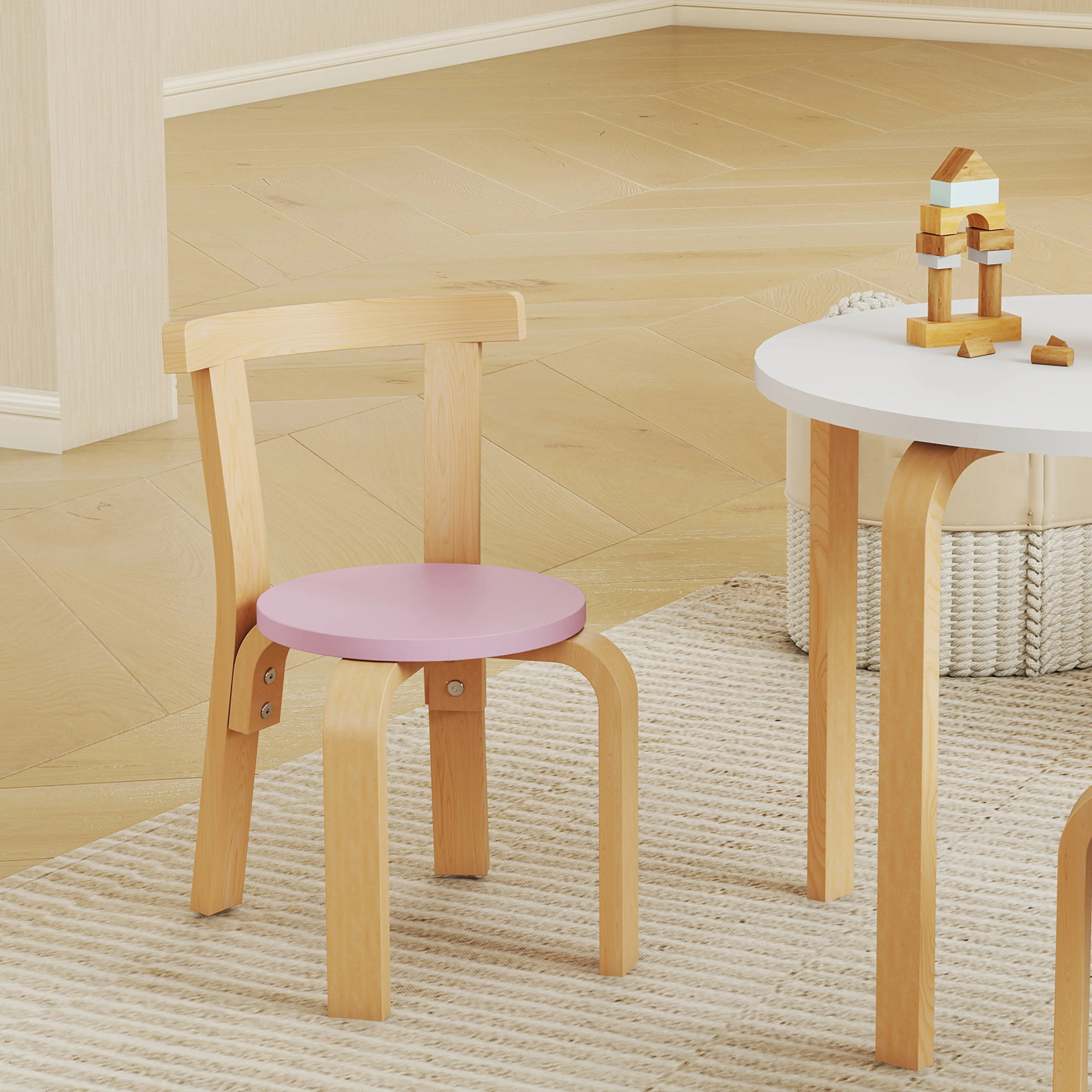 En stol med rosa sits bredvid barnbordet