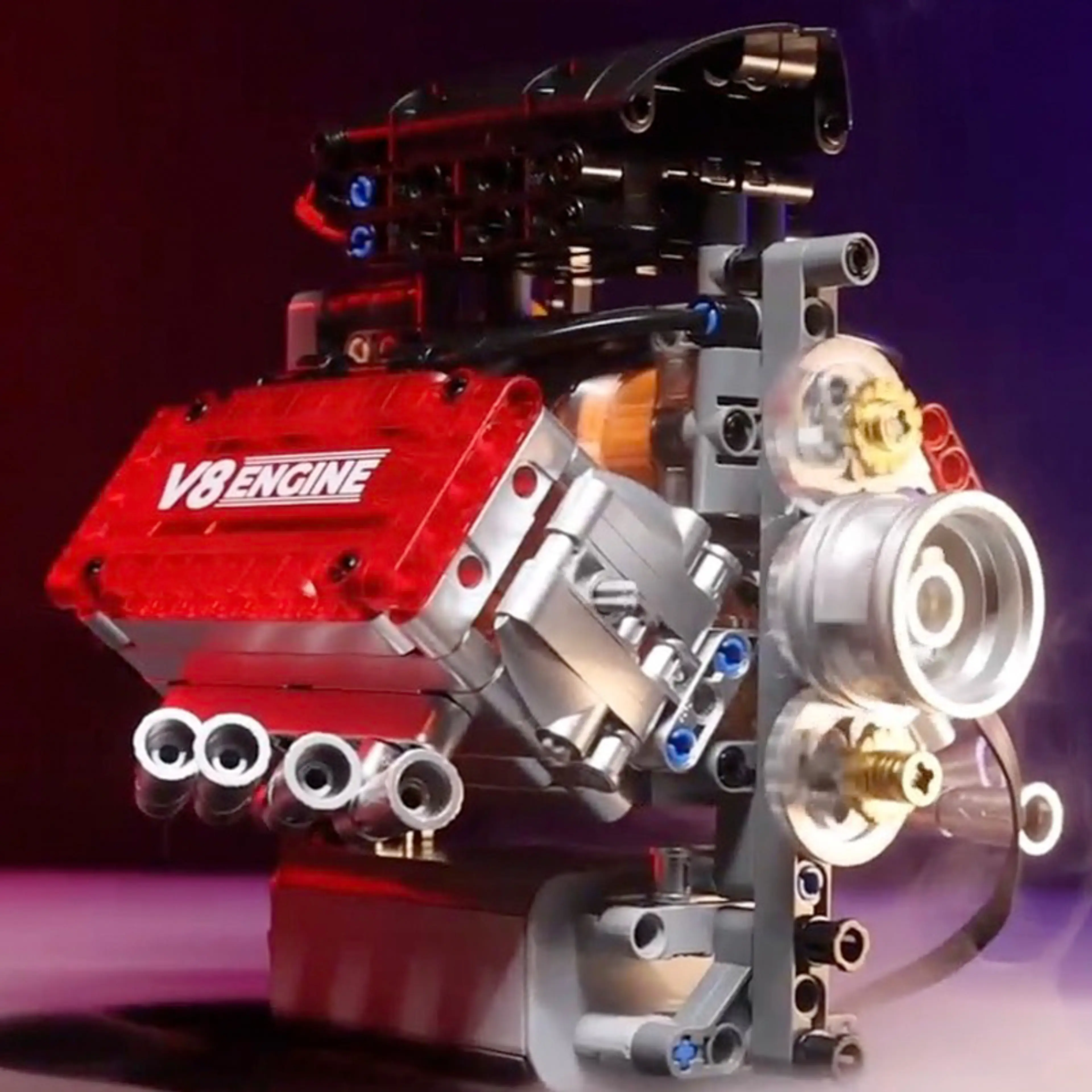 V8-motorn framifrån med genomskinligt rött cylinderlock, remskivor och åtta avgasportar
