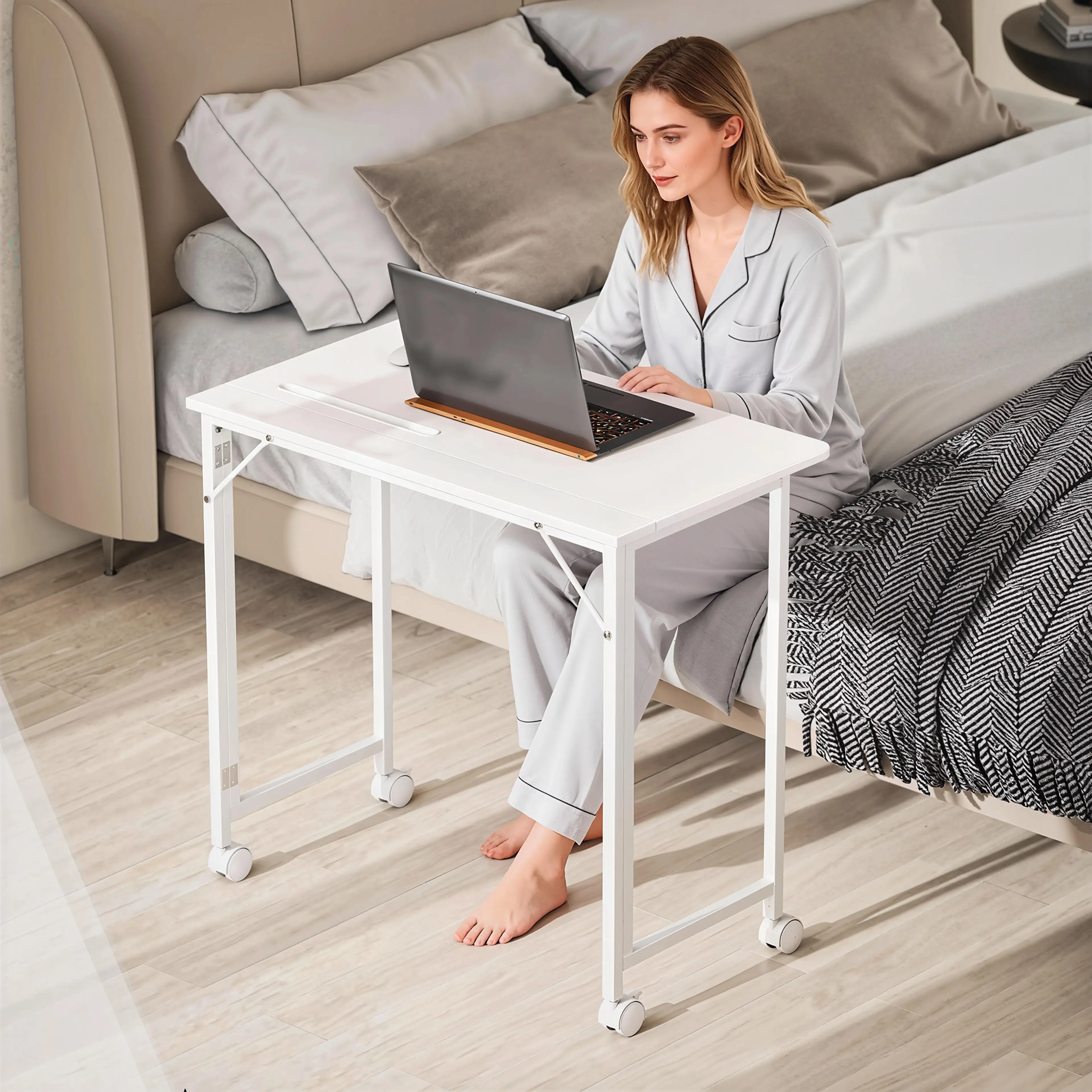 Bordet rullat intill sängen och använt som arbetsplats med laptop