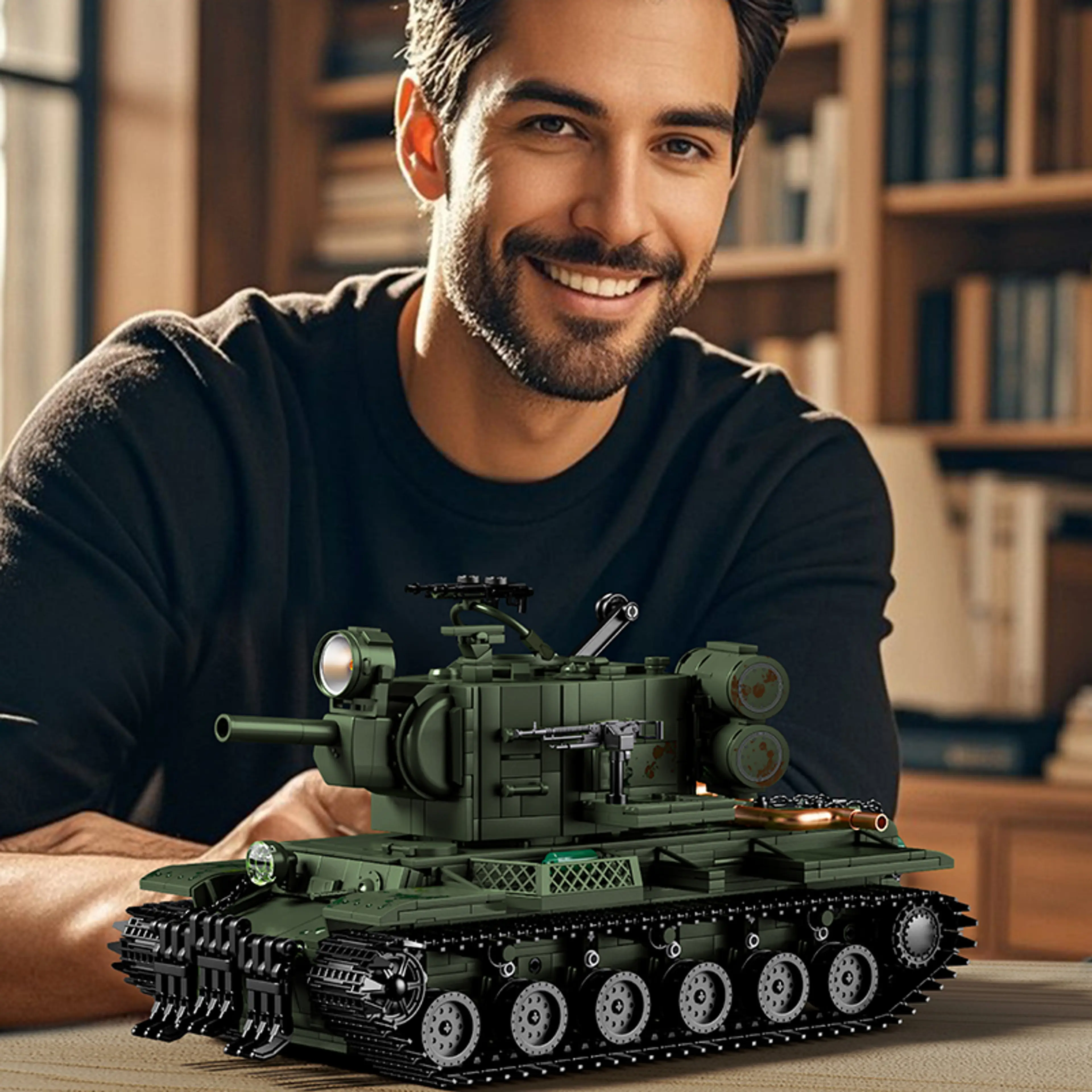 Vuxen man vid ett skrivbord med den färdigbyggda KV-2:an i klossar