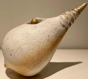 White ceramic artwork with gold decorations and patterns. Exhibited at the 410 Gallery.