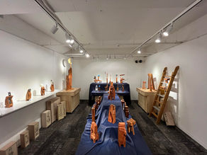 410 Gallery is an art gallery with an exhibition of wooden sculptures. This is a view of an art gallery where sculptures are on display.