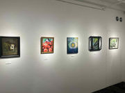 White walls are decorated with paintings. Artworks from the art gallery 410 Gallery are lined up.