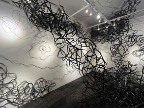 Black line artwork, lines painted on a white wall, light. Museum exhibition. Art Gallery 410 Gallery.