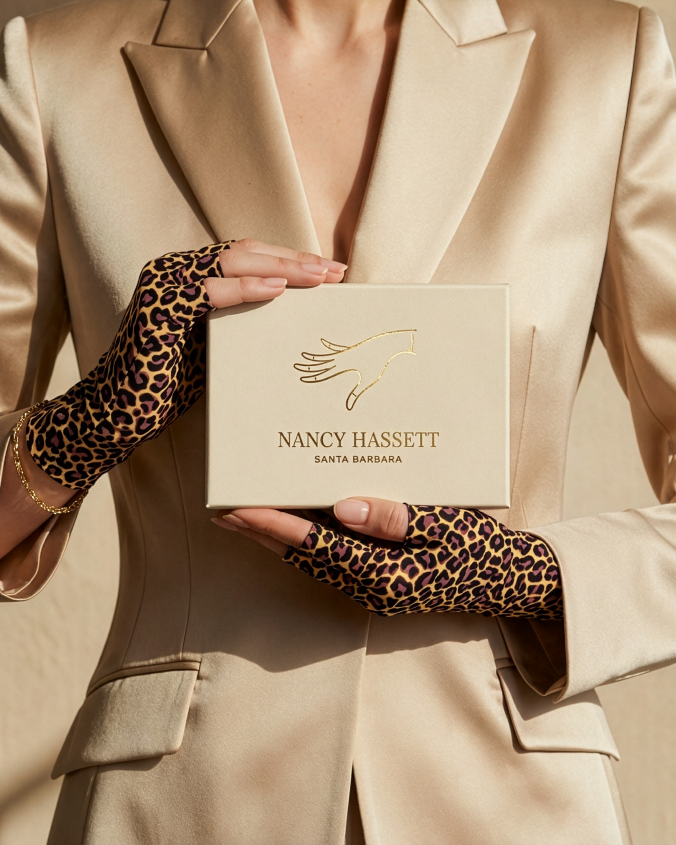 Nancy Hassett animal-print fingerless gloves with cream branded presentation packaging