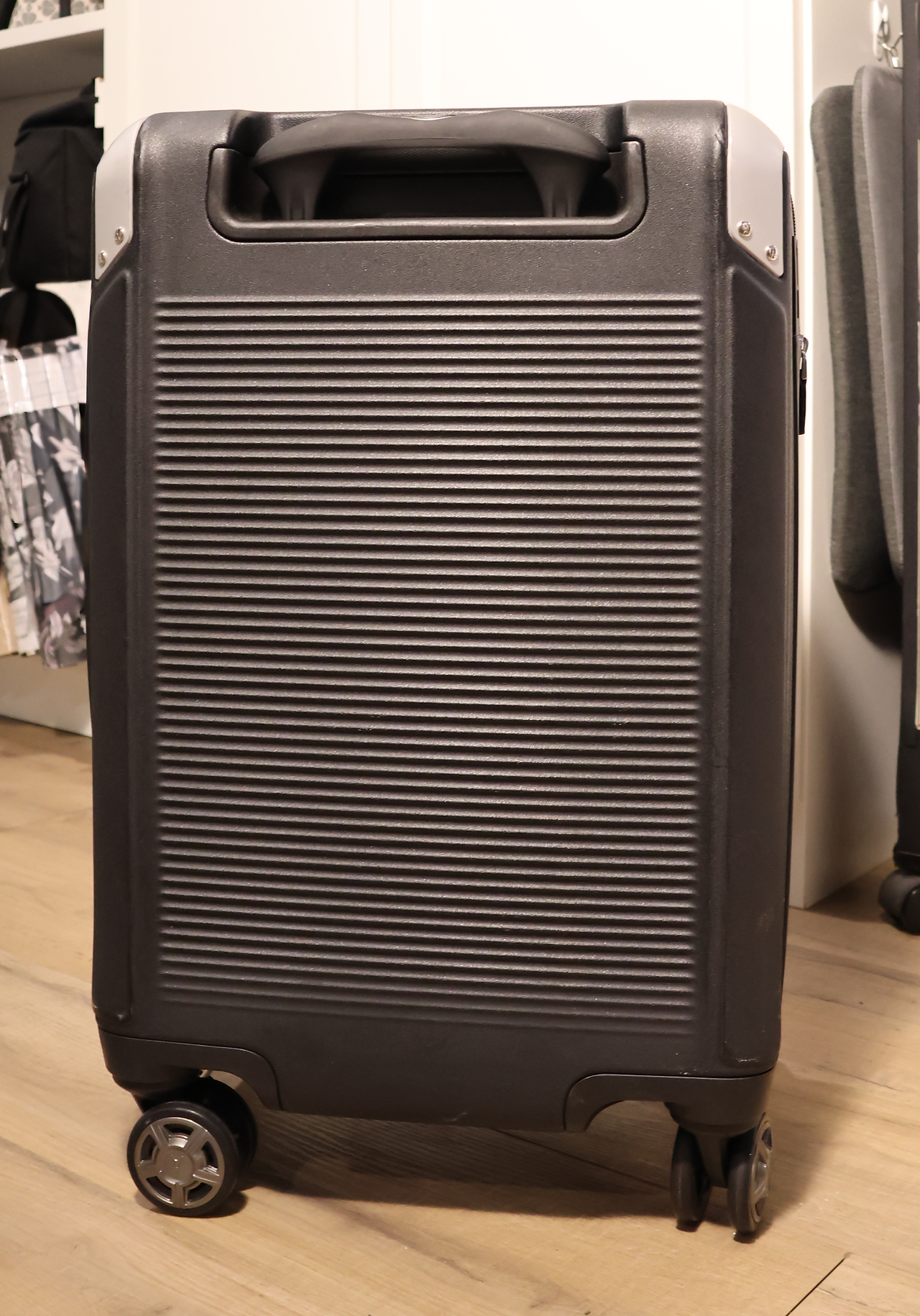 Back of a black Travelpro carryon suitcase with silver accents