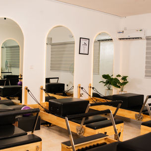 A bright Pilates studio in Abuja with reformer machines ready for beginners