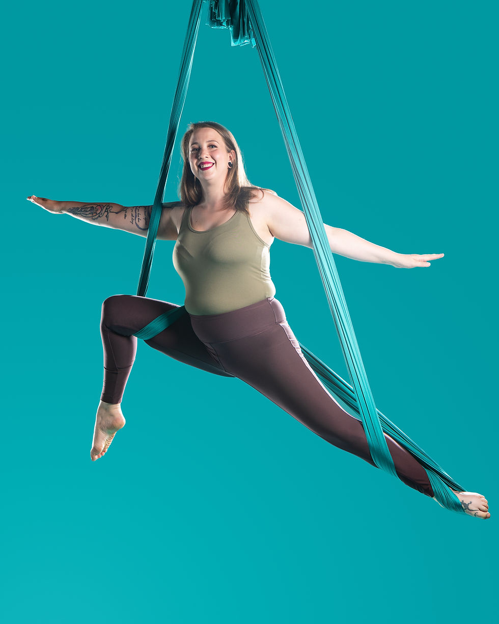Instructor performing a hammock move in an aerial hammock.