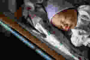 newborn baby in hospital bassinet
