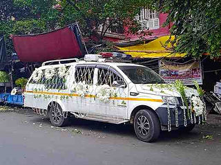 Decorated floral hearse vehicle in Kolkata prepared for funeral processions, memorial services, and respectful final journey transportation