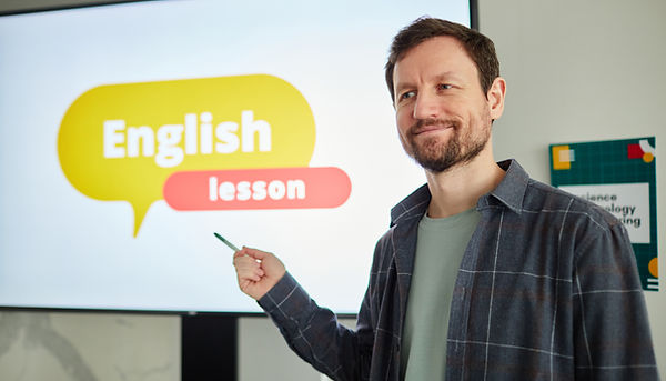 waist-up-portrait-bearded-male-teacher-pointing-digital-whiteboard-with-english-lesson-tex