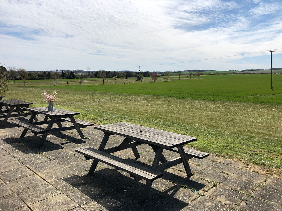 Picnic benches overlooking farm