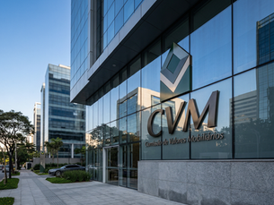 Fachada de prédio corporativo moderno com painéis de vidro refletivos, exibindo a logo da CVM e a inscrição “Comissão de Valores Mobiliários” de forma institucional e elegante, em ambiente urbano que transmite autoridade, credibilidade e solidez regulatória.