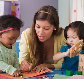 Children and speech-language therapist playing and coloring