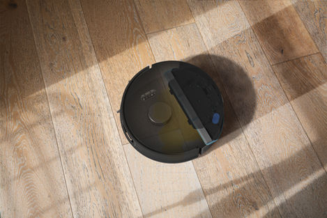 UltraVision pet robot vacuum mopping up a spill with inner parts showing