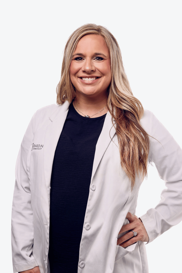 Mackenzie Johnson, NP, smiling in a white medical coat.
