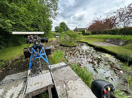 Truxor removing reeds, silt and lilies