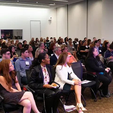 Crowd of donors watches presentation by NIMBLE Mindset on democratizing access to entrepreneurship training.