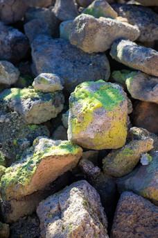 pile of rocks with yellow sulfur deposits on the surface