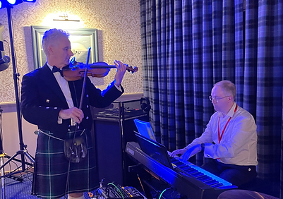 Fiddle and piano duo performing for an event at RAF Lossiemouth