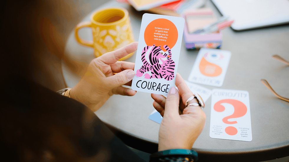 hands holding card that says courage