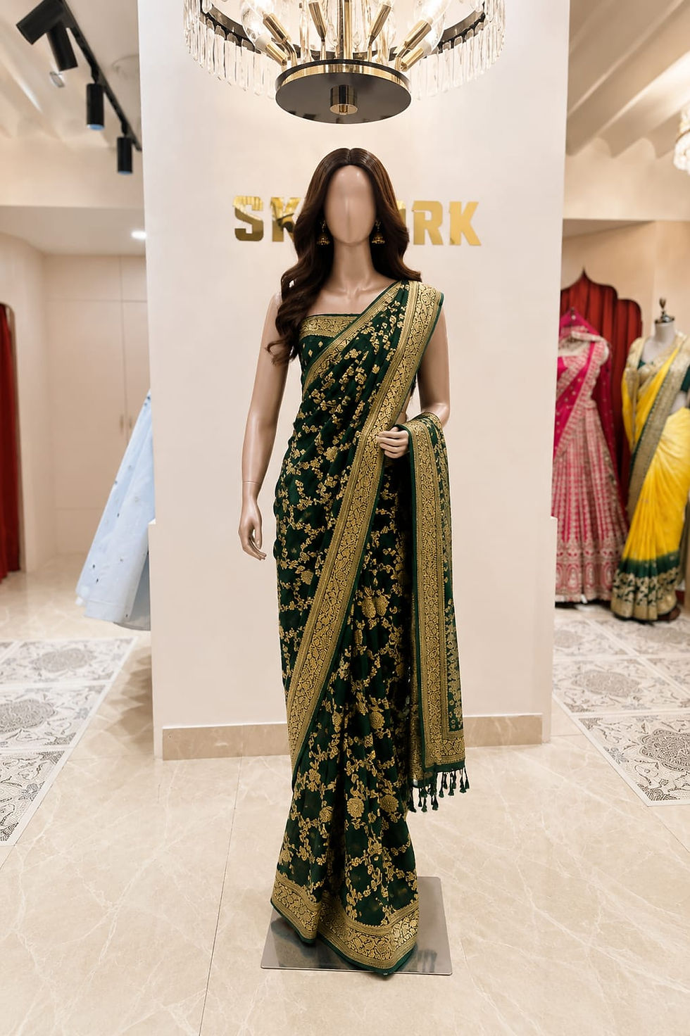 Elegant emerald green georgette semi khaddi saree with intricate gold zari weaving, traditional border, tassel pallu.