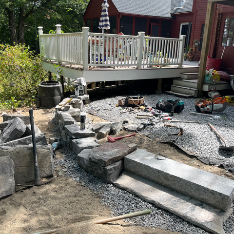 Flagstone Pathways, Chunk Granite Retaining Wall, Granite Step and Landing, River Round Sitting Area, and Arbor Bed with New Mulch. Newmarket, NH.