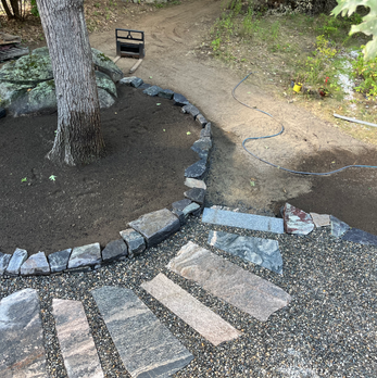 Flagstone Pathways, Chunk Granite Retaining Wall, Granite Step and Landing, River Round Sitting Area, and Arbor Bed with New Mulch. Newmarket, NH.